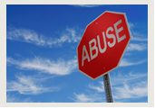 A red stop sign with the word abuse written underneath it.