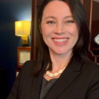 Smiling woman in a professional setting.