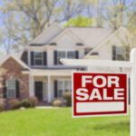 House with a "For Sale" sign.