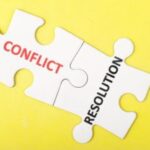 Puzzle pieces labeled conflict and resolution.