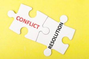 Puzzle pieces labeled conflict and resolution.