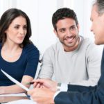 Financial consultant presents bank investments to a young couple