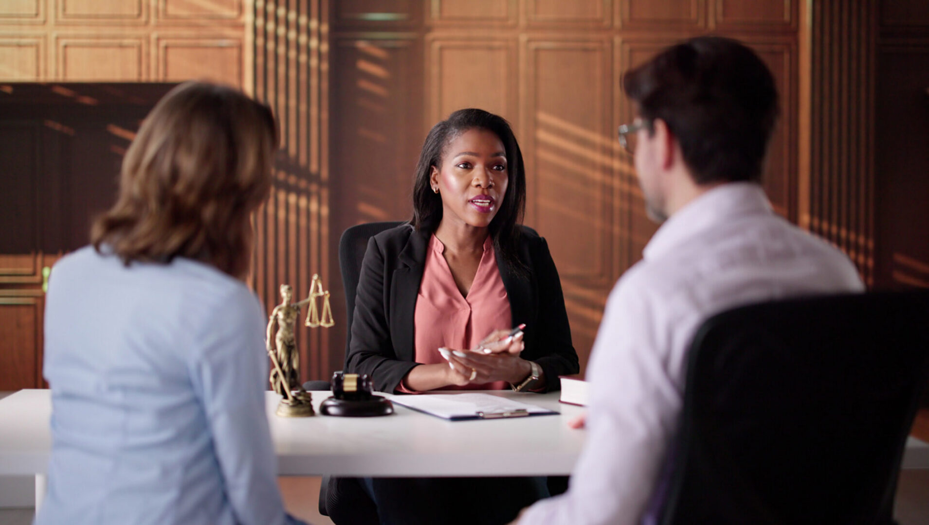 Lawyer consulting clients in an office setting.