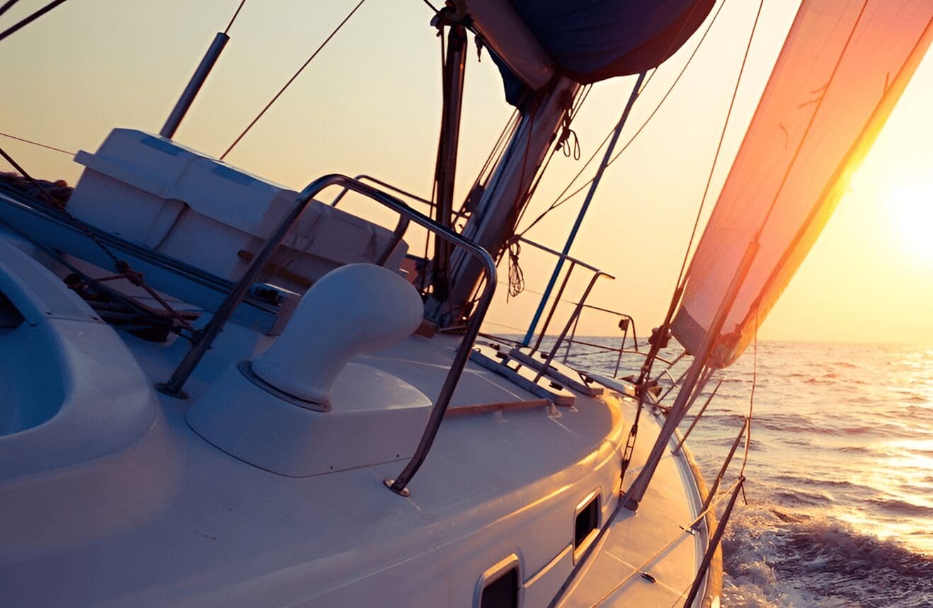 Sailboat on ocean at sunset.