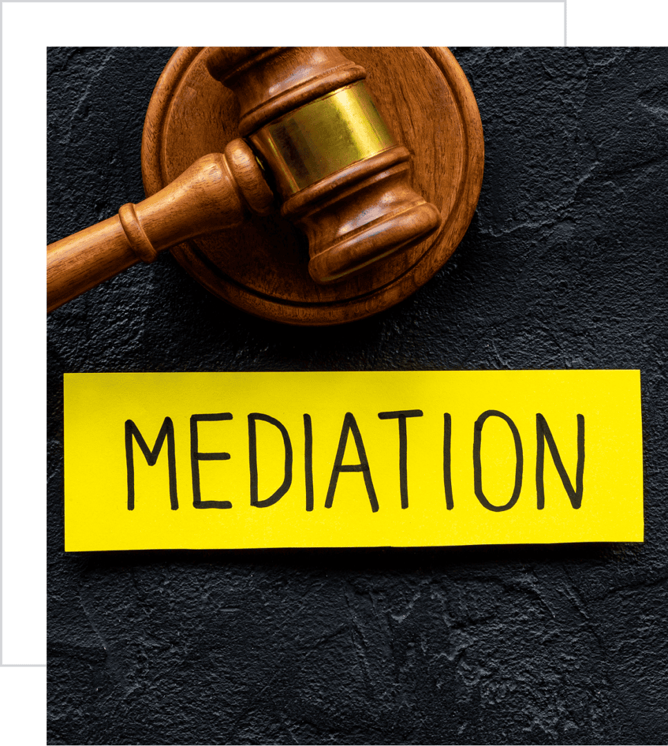 Gavel with "Mediation" sign on yellow paper.