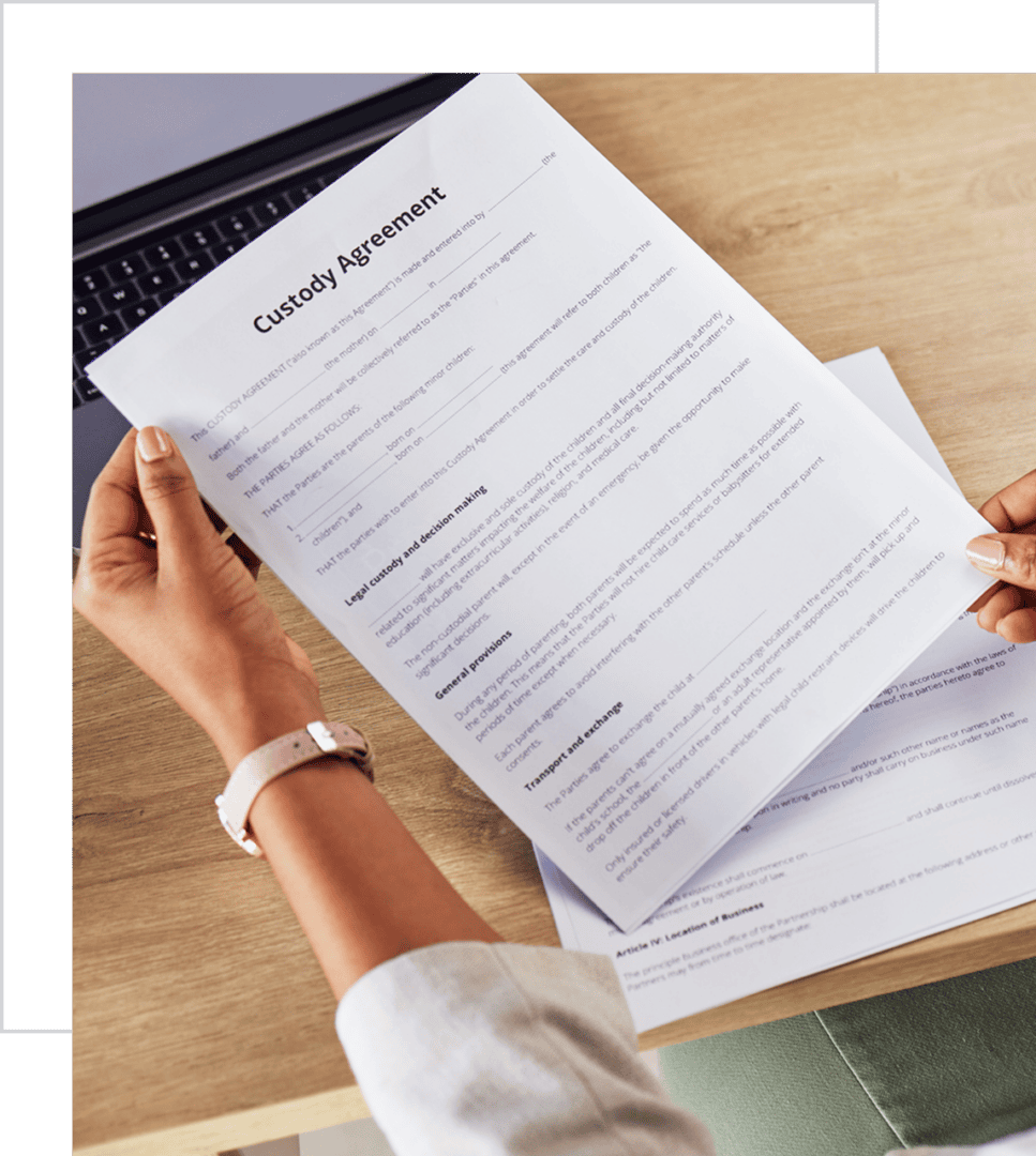 Person holding a custody agreement document.