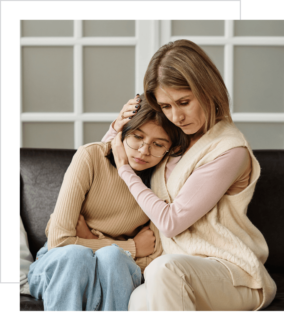 A comforting embrace between two women.