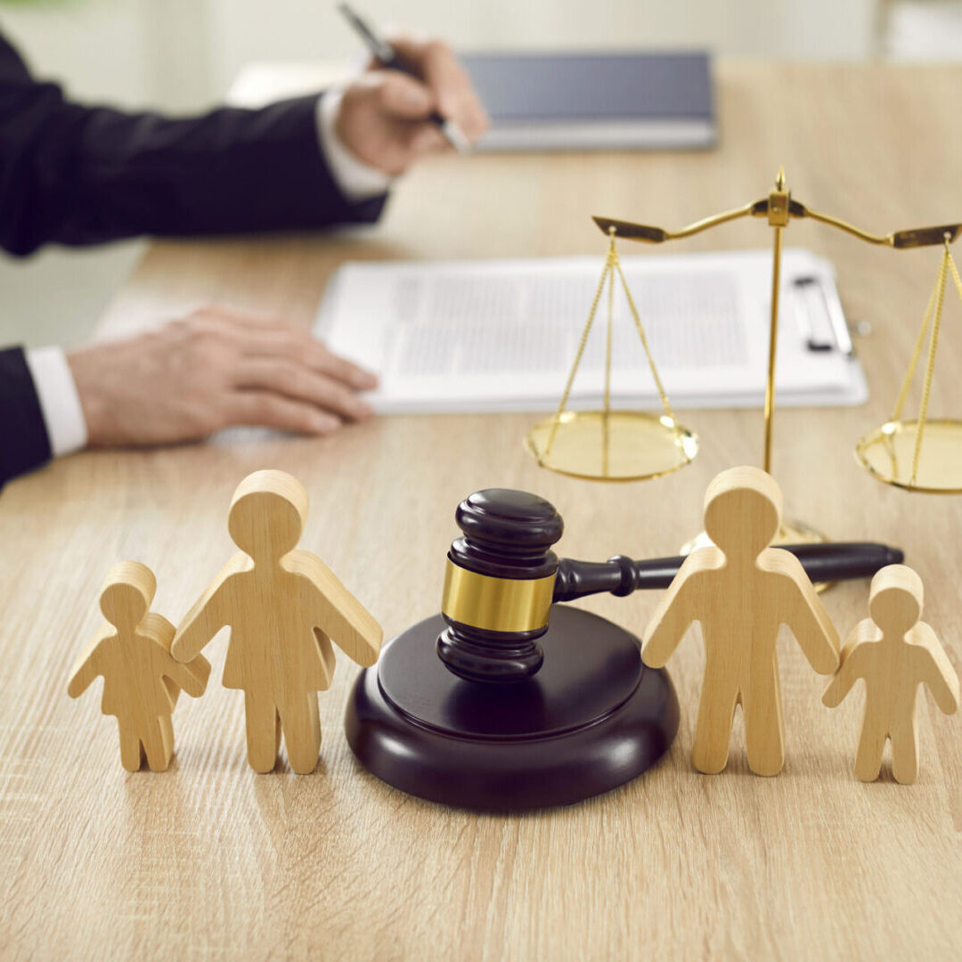 Judge's desk with gavel and family figures.